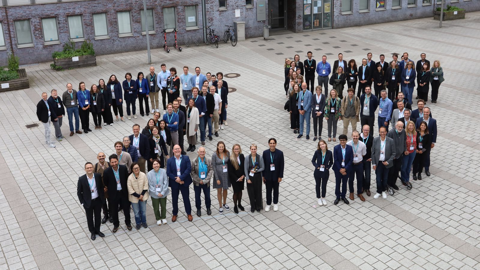 Participants of the 25th International CINet Conference gathered for a group photo in a courtyard in Hamburg